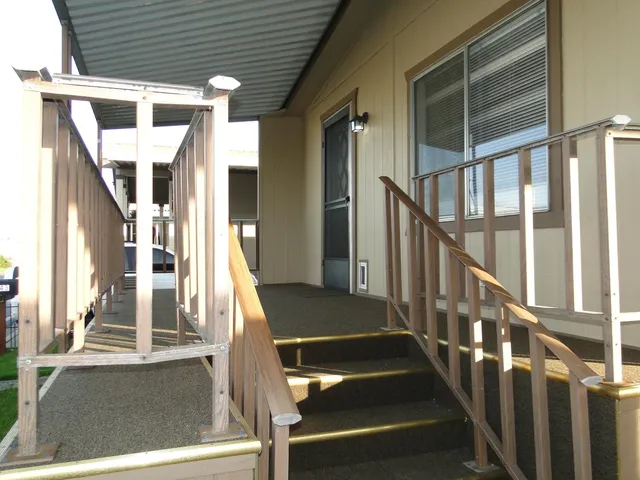 a view of staircase with railing and white walls