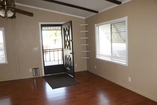 15820 South Harlan Road, Unit 143 Lathrop, CA 95330 - Photo 7 of 40 a view of an empty room with wooden floor and a window