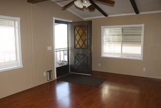 15820 South Harlan Road, Unit 143 Lathrop, CA 95330 - Photo 10 of 40 an empty room with wooden floor and windows