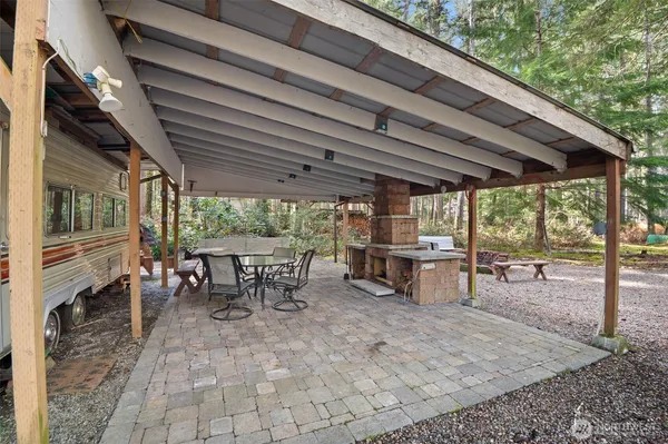 a view of a patio with table and chairs