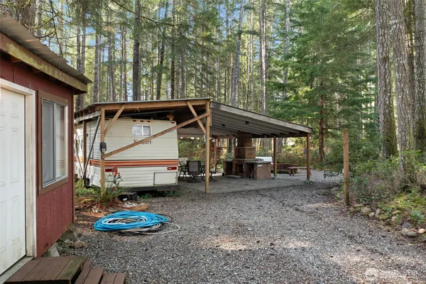 a view of a chair and table in backyard