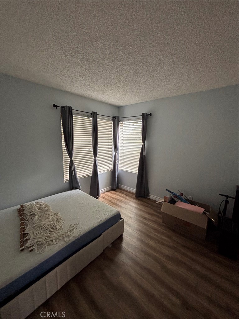 38 Springacre Irvine, CA 92614 - Photo 11 of 19 a bedroom with a bed and wooden floor