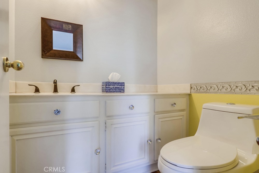 38 Springacre Irvine, CA 92614 - Photo 12 of 19 a bathroom with a toilet sink vanity and mirror