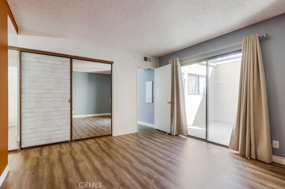 38 Springacre Irvine, CA 92614 - Photo 13 of 19 an empty room with wooden floor and windows