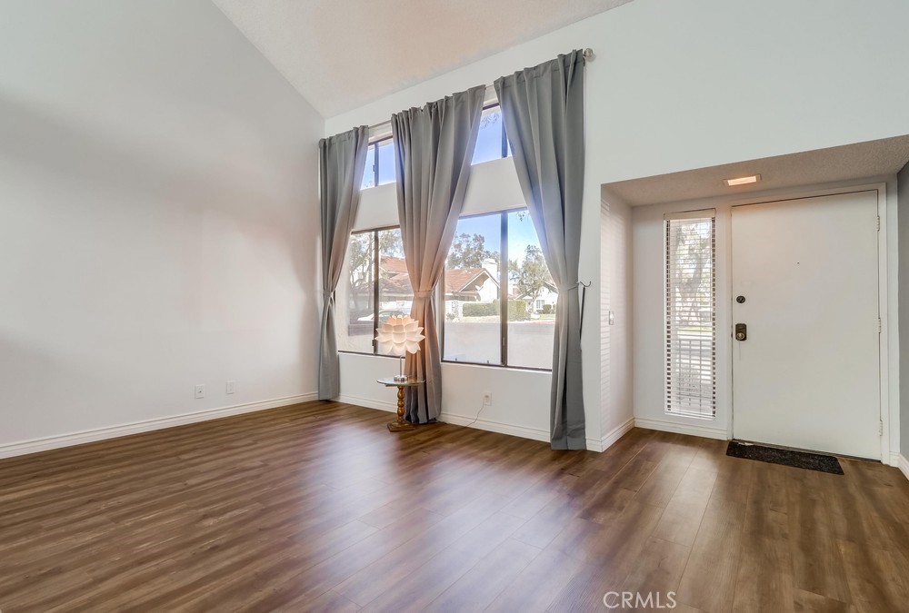 38 Springacre Irvine, CA 92614 - Photo 5 of 19 an empty room with wooden floor and windows