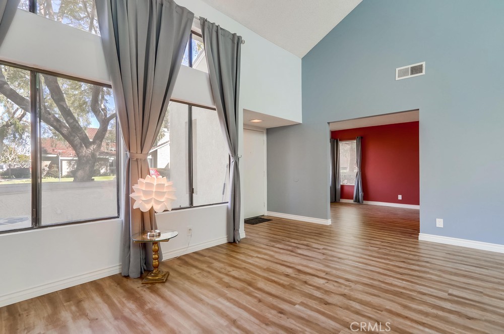 38 Springacre Irvine, CA 92614 - Photo 6 of 19 a view of hallway with a large window and wooden floor