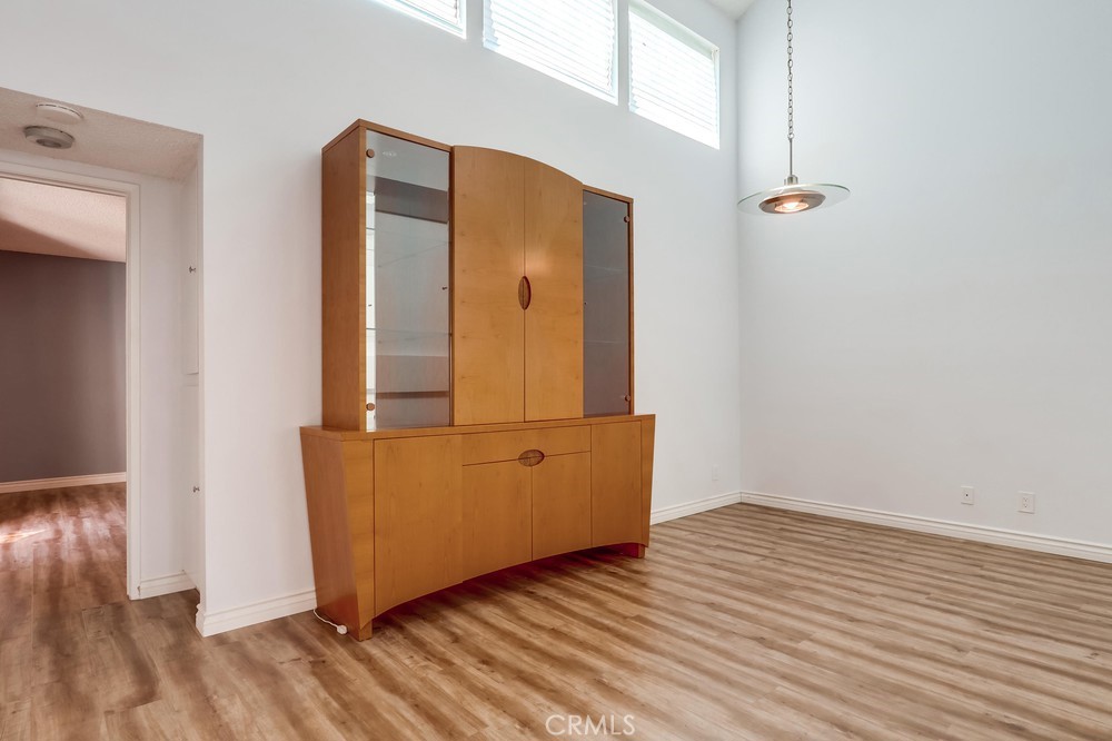 38 Springacre Irvine, CA 92614 - Photo 8 of 19 an empty room with wooden floor and mirror