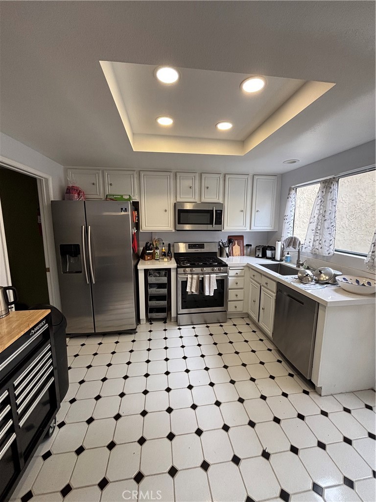 38 Springacre Irvine, CA 92614 - Photo 10 of 19 a kitchen with granite countertop a sink a counter top space cabinets and stainless steel appliances