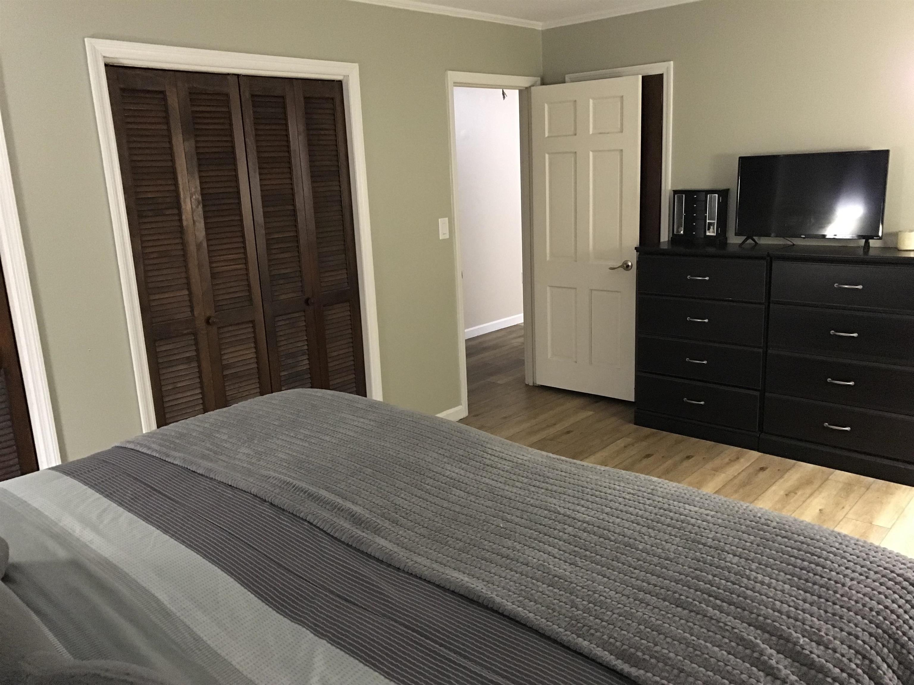 1201 Landgrave Street Georgetown, SC 29440 - Photo 37 of 38 Bedroom featuring ornamental molding, light wood-style floors, and a closet