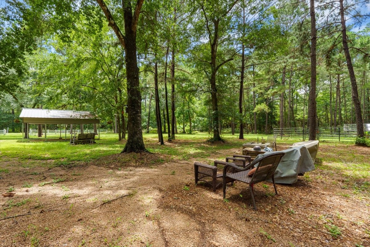 16375 Grand Flower Road Plantersville, TX 77363 - Photo 34 of 50 a view of a wooden bench sitting in the park