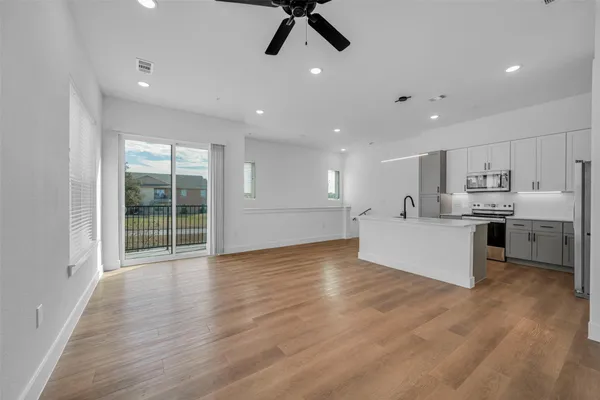 a view of kitchen with stainless steel appliances refrigerator oven and cabinets