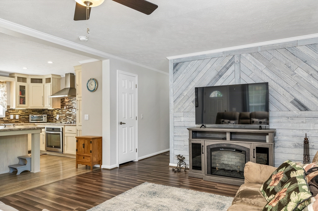 10 Ashleigh Lane, Unit 10 Rochester, NH 03867 - Photo 20 of 42 a living room with a fireplace and a flat screen tv