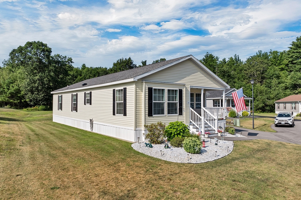 10 Ashleigh Lane, Unit 10 Rochester, NH 03867 - Photo 2 of 42 a front view of house with yard and green space