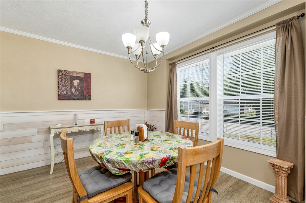 10 Ashleigh Lane, Unit 10 Rochester, NH 03867 - Photo 23 of 42 a view of a dining room with furniture window and wooden floor