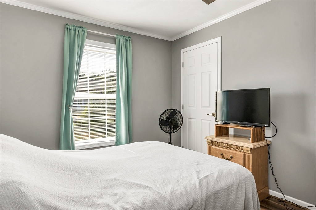 10 Ashleigh Lane, Unit 10 Rochester, NH 03867 - Photo 26 of 42 a bedroom with a bed and a flat screen tv