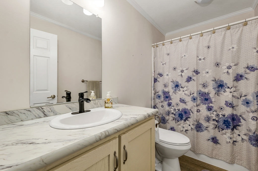10 Ashleigh Lane, Unit 10 Rochester, NH 03867 - Photo 30 of 42 a bathroom with a granite countertop sink and a mirror