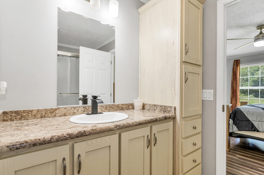 10 Ashleigh Lane, Unit 10 Rochester, NH 03867 - Photo 39 of 42 a bathroom with a granite countertop sink and a mirror