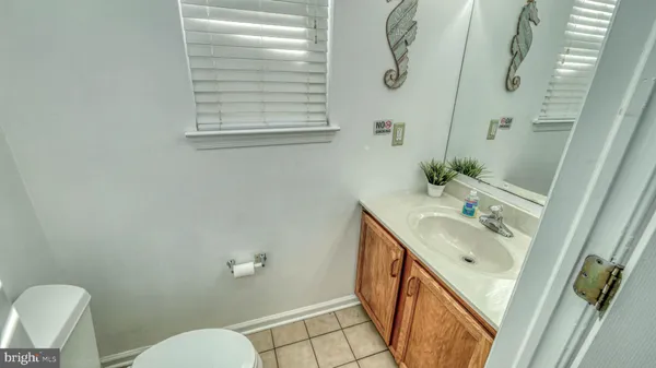 a bathroom with a sink a toilet a mirror and shower