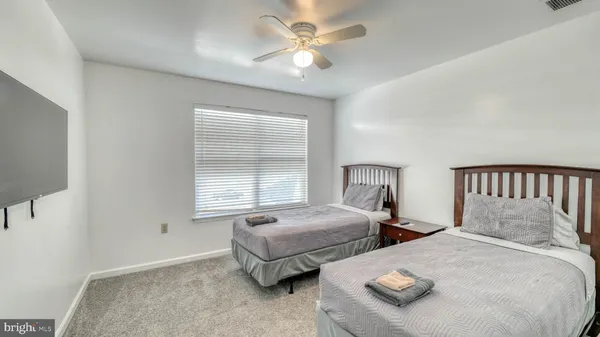 a bedroom with two beds and a window