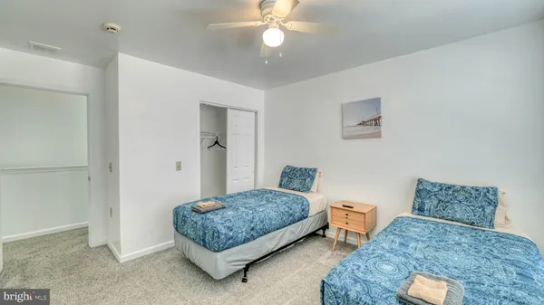 a bedroom with bed and a chandelier