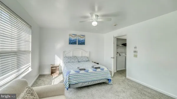 a spacious bedroom with a bed and a chandelier