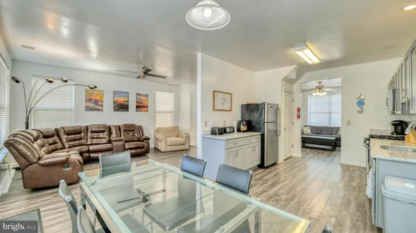 a living room with furniture and a kitchen