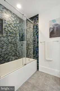a bathroom with a bathtub and a shower