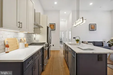 a kitchen with a sink stove and wooden cabinets