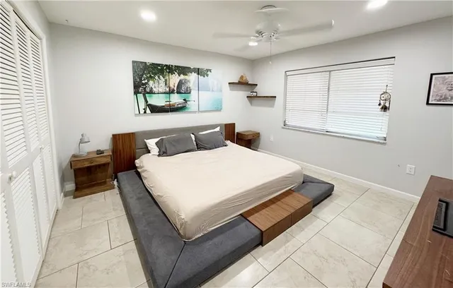 a bedroom with a bed and window