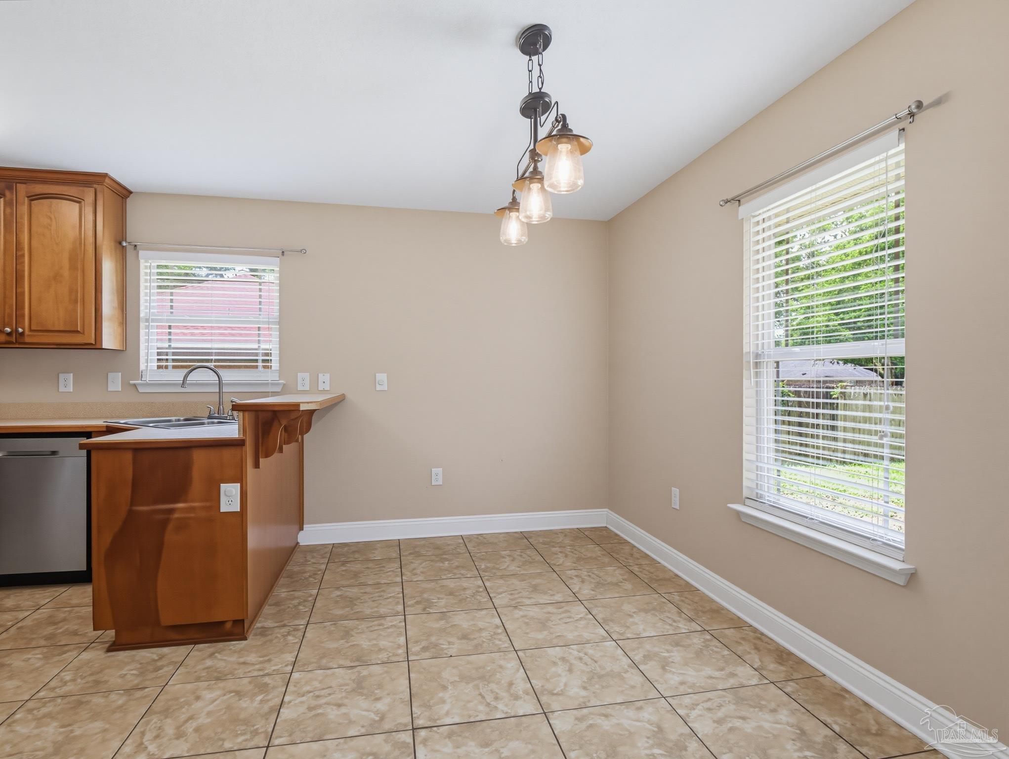 5567 Jones Street Milton, FL 32570 - Photo 13 of 48 a kitchen with a sink cabinets and window