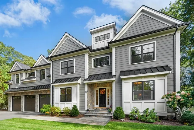 a view of a brick house with yard and plants