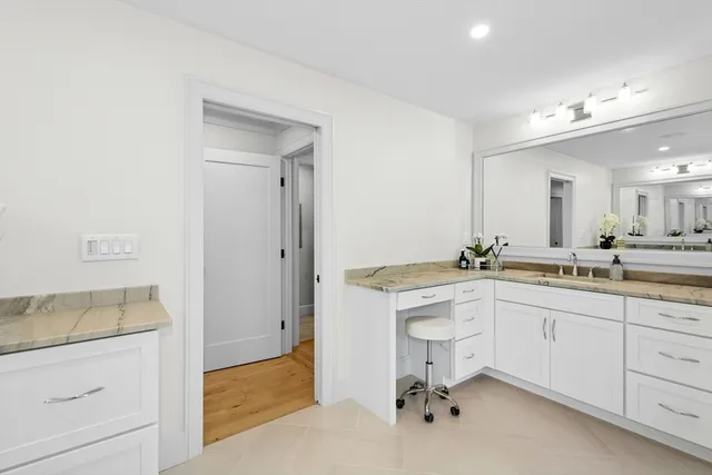 a spacious bathroom with a granite countertop sink mirror and vanity