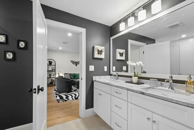 a spacious bathroom with a granite countertop sink mirror and