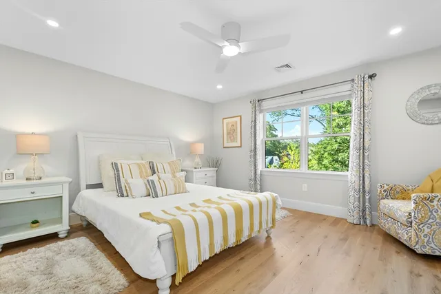 a bedroom with a large bed and a window