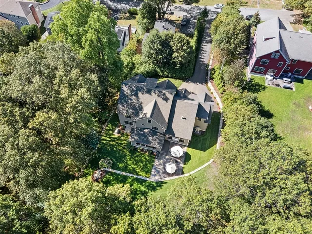 an aerial view of a house with a yard and garden
