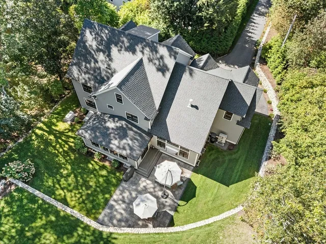 an aerial view of a house with a yard garage and outdoor seating