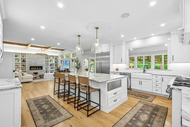 a large kitchen with kitchen island a large counter space a sink and appliances