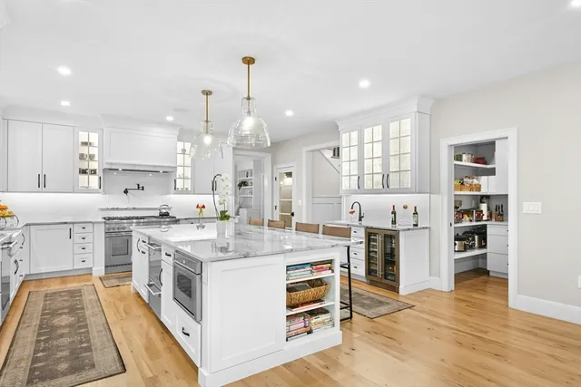 a large kitchen with stainless steel appliances granite countertop a stove and a refrigerator