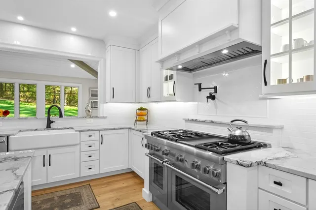 a stove top oven sitting inside of a kitchen