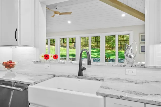 a bathroom with a tub and window