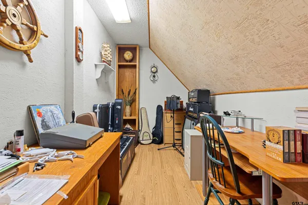 a view of a room with wooden floor and furniture