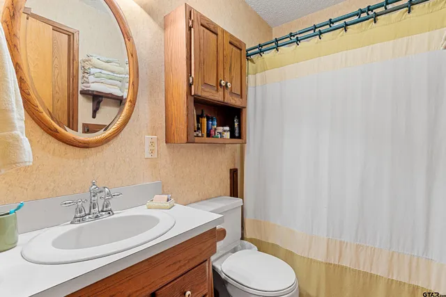 a bedroom with bed and a chandelier