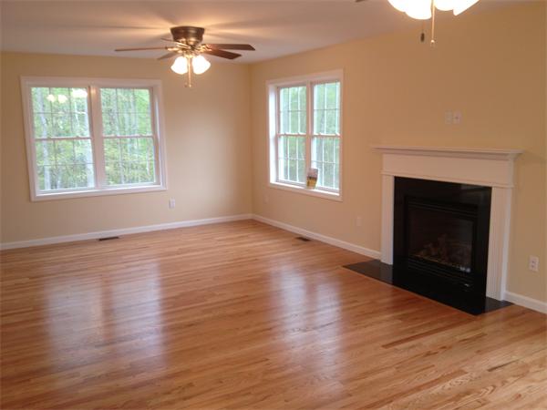 5 Birch Road Freetown, MA 02702 - Photo 14 of 25 an empty room with wooden floor fireplace and a window