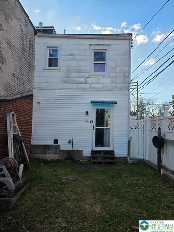 a view of a backyard with plants and a patio