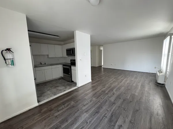 a view of kitchen with sink and refrigerator