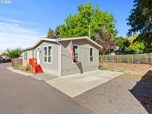 a view of a house with a garage and yard