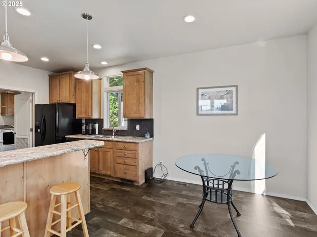 a kitchen with stainless steel appliances kitchen island granite countertop a sink and cabinets