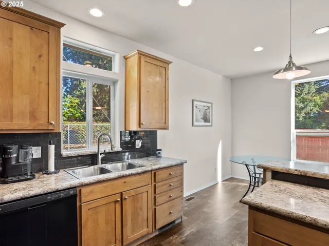a kitchen with granite countertop a sink and a window