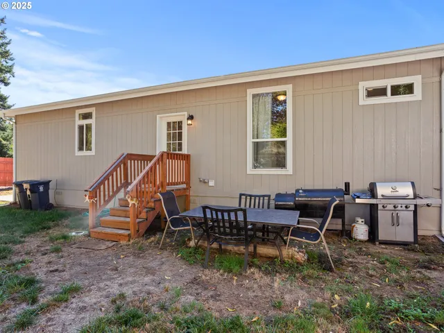 a view of a house with yard and sitting area