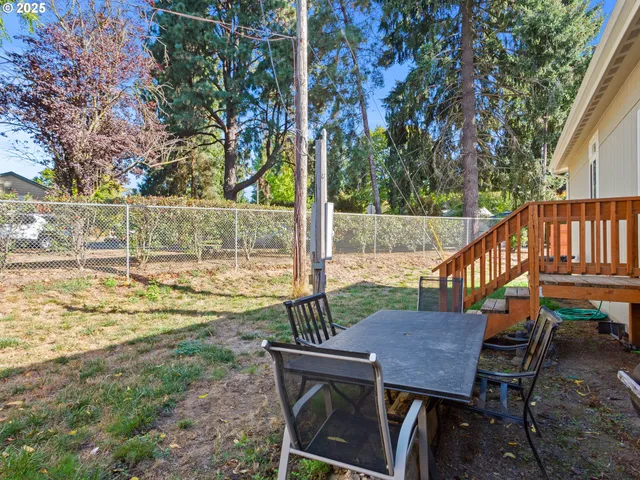 a view of a wooden deck and a backyard